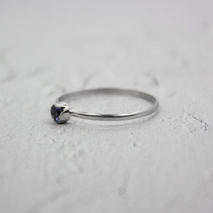 Sterling silver ring featuring a dainty Iolite solitaire gemstone, designed by Grey Clymene in jewelry and watches.
