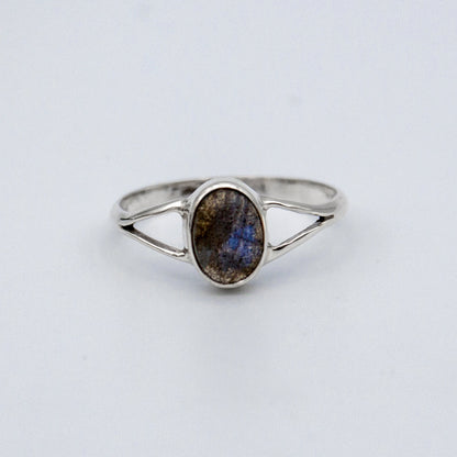 Oval Labradorite bezel split shank sterling silver ring from Grey Clymene, showcasing a shimmering labradorite gemstone and intricate band design.
