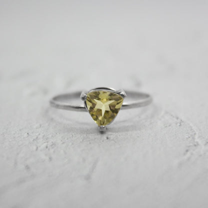 Sterling silver Lemon Topaz trillion-shaped solitaire ring featuring a bright yellow gemstone in a sleek jewelry design.