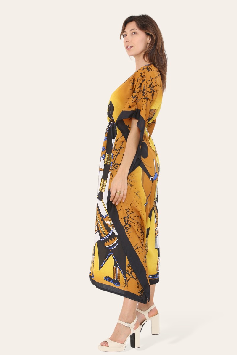 Women’s traditional African style caftan dress with vibrant print, featuring mustard color and flowing fabric by Coffee Diomedes.