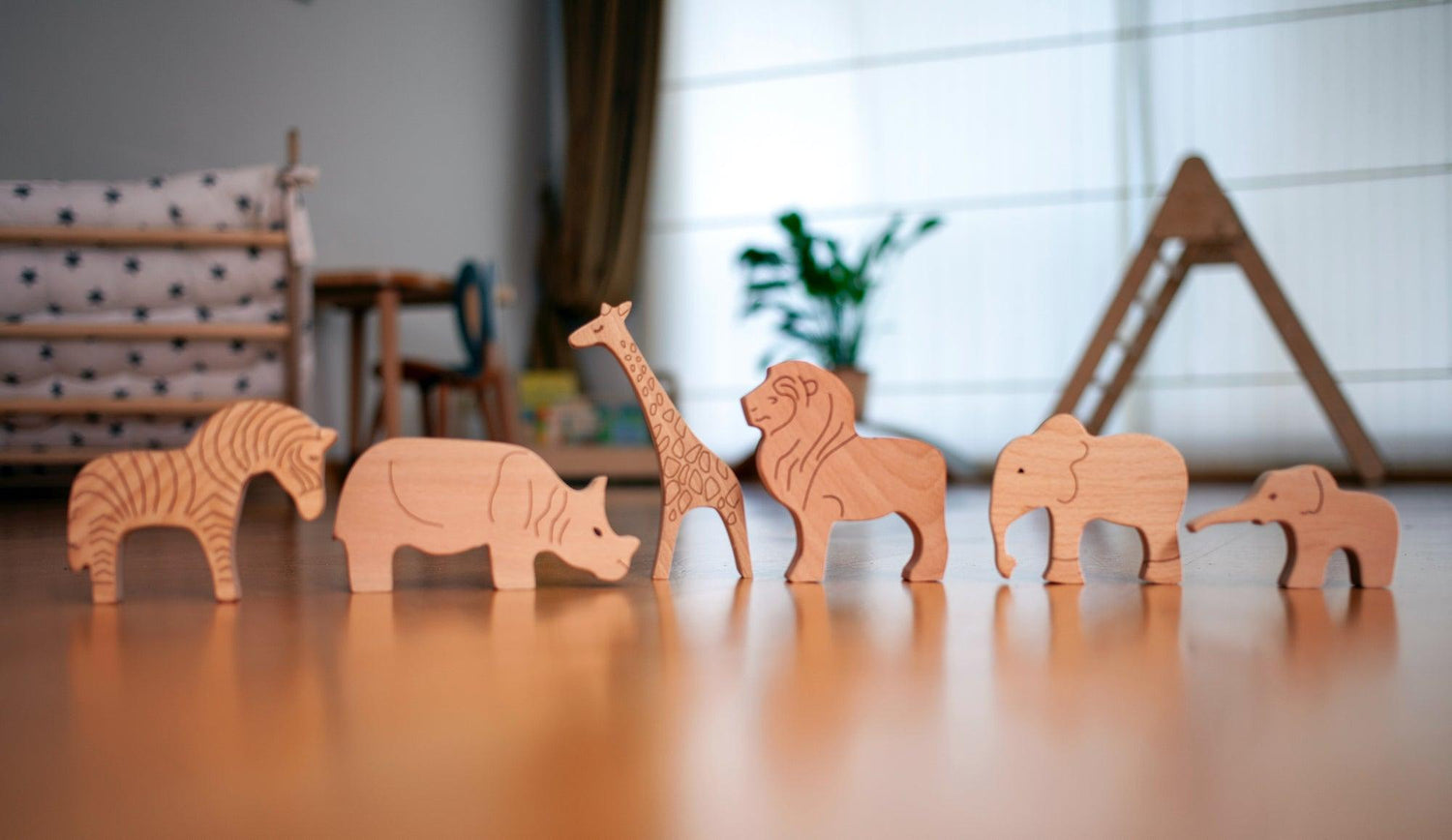 Set of wooden safari animal figurines from Red Oceanus, featuring detailed handcrafted zebra, lion, elephant, and giraffe figures.