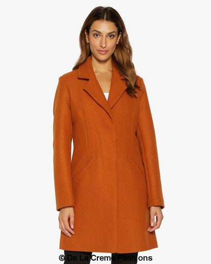 Rose Eleusis Sara Covert button-up coat in a stylish jacket with a classic collar and button details, displayed on a hanger.