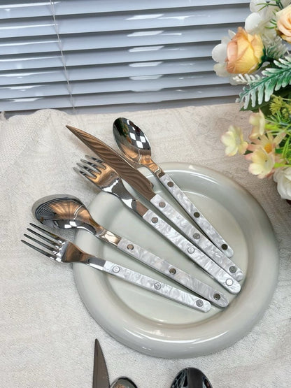 Set of 10 modern nebula cutlery pieces in bistrot style with rivet details, ideal for stylish home decor and table settings.