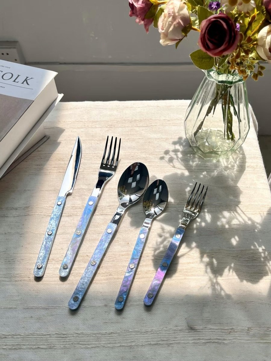 Set of 10 modern Nebula cutlery in Bistrot style with rivet details, featuring sleek flatware for stylish home decor.