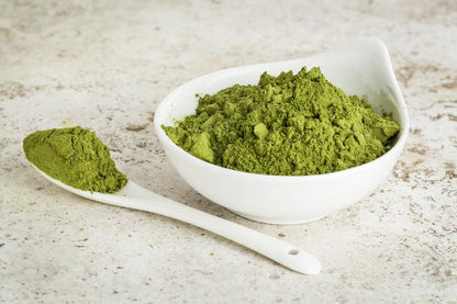 Azure Eurybia Hair Bliss Aloe Vera herbal conditioning powder in a bowl, featuring fresh aloe vera leaves and herbal ingredients.