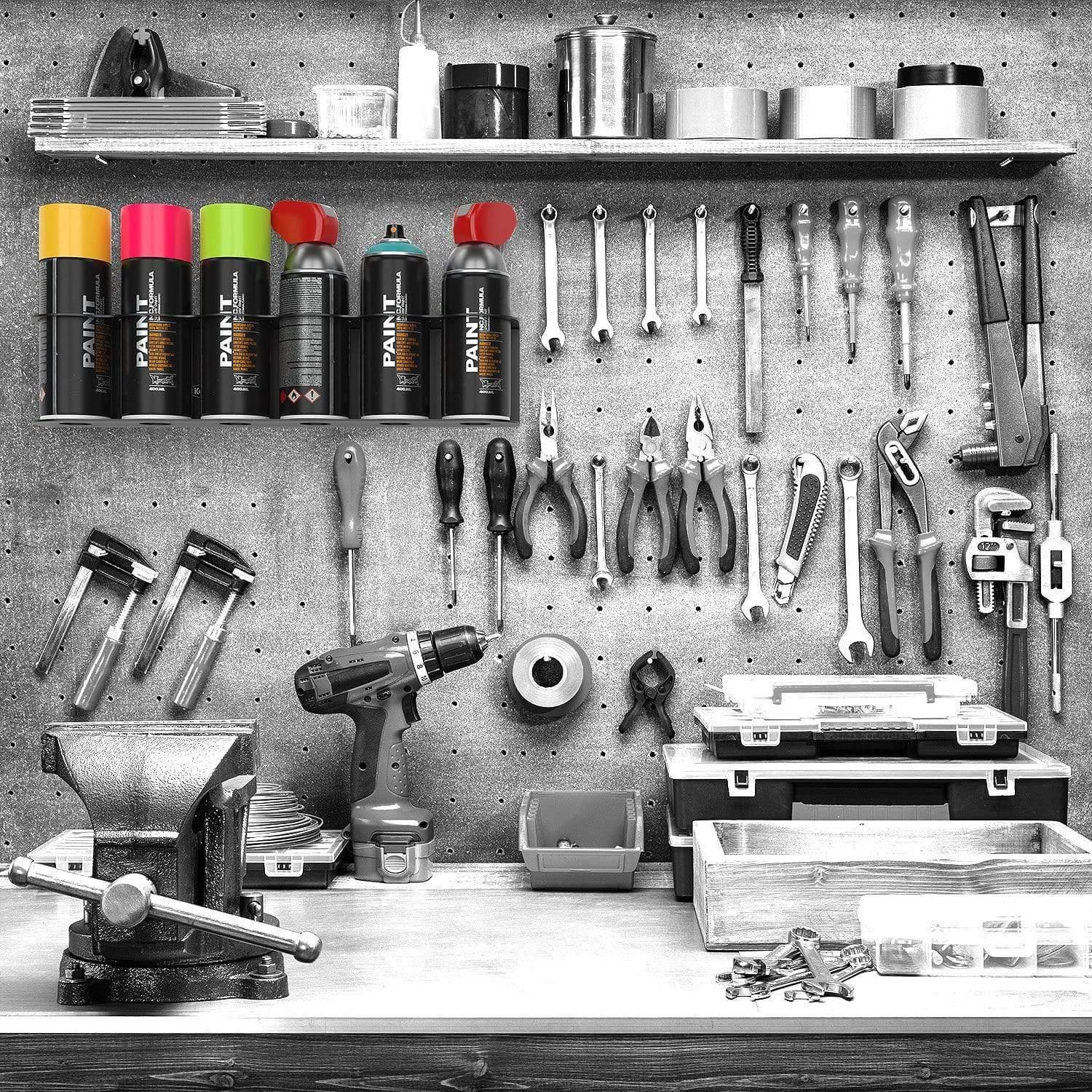 Black aerosol spray can holder for six cans, mounted on a workbench, made by Crimson Astraeus for organizing spray cans.