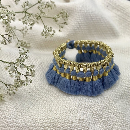 Ariel Kyra Tassel Bracelet featuring slate-colored beads and tassel accents, styled on a neutral background.