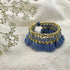 Ariel Kyra Tassel Bracelet featuring slate-colored beads and tassel accents, styled on a neutral background.