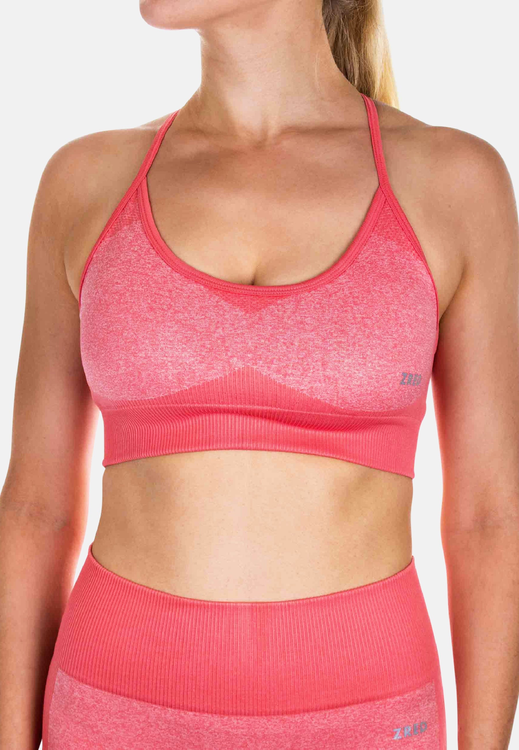 Pink Pear Juniper Sports Bra ICON for women, shown from the side with orange accents, designed for activewear and comfortable support.