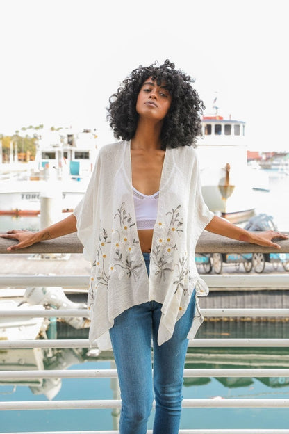 Light pink Spring Daisy Kimono blouse from Periwinkle Aether featuring a floral pattern and flowy fabric, perfect for casual wear.