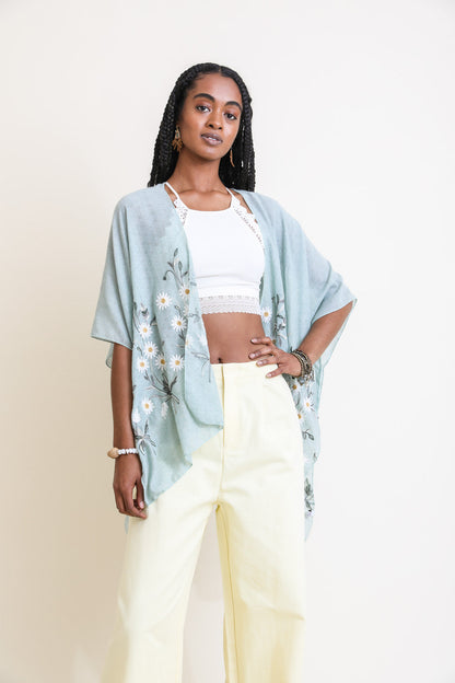 Mint green Spring Daisy Kimono from Periwinkle Aether, featuring floral patterns and lightweight fabric, styled as a blouse or top.