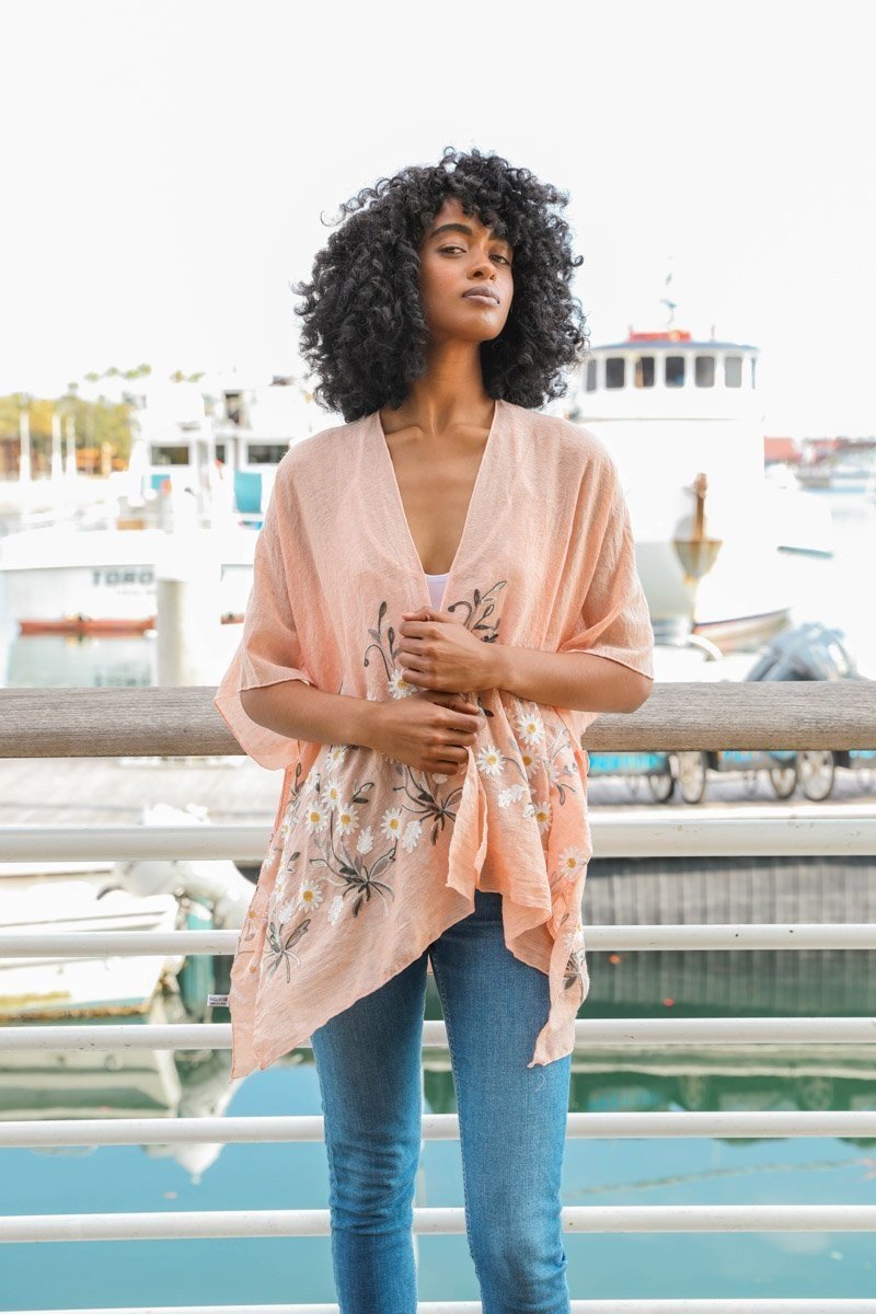 Peach-colored spring Daisy Kimono by Periwinkle Aether, lightweight blouse with floral print, long sleeves, and elegant design.
