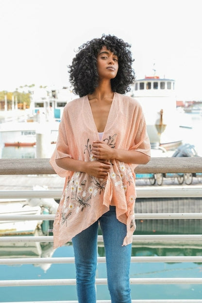 Peach Spring Daisy Kimono by Periwinkle Aether, lightweight blouse with floral daisy pattern, flowy sleeves, and open front.