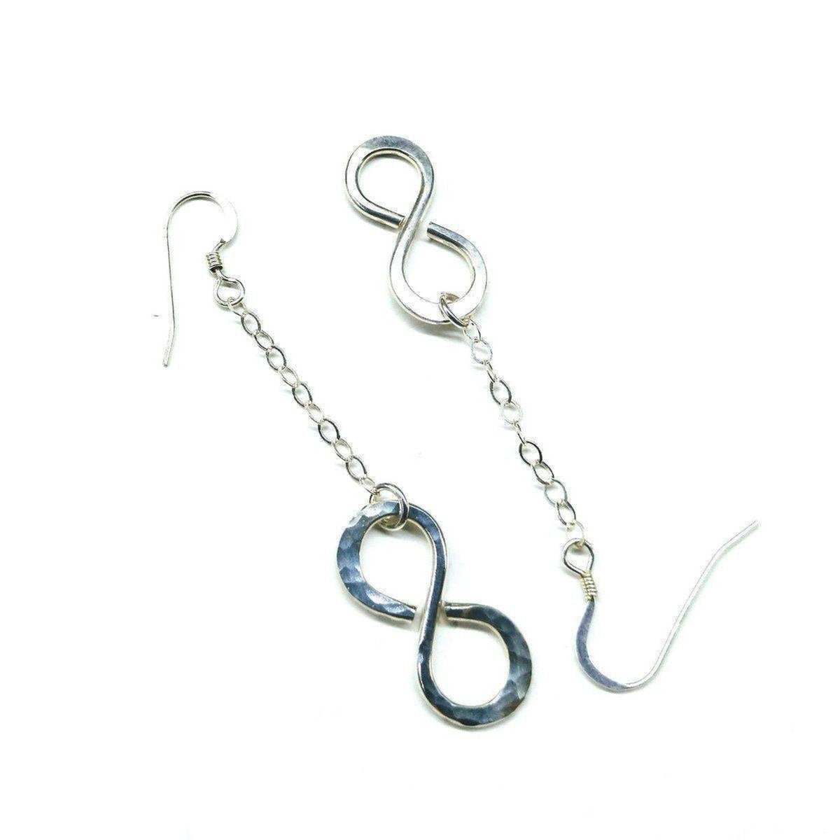 Sterling silver infinity earrings with hammer pattern by Blue Crius, showcasing elegant and textured jewelry design.