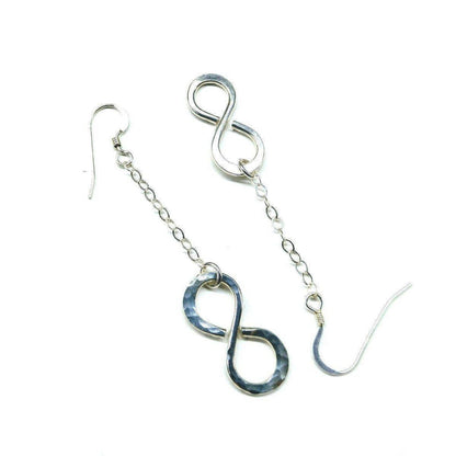 Sterling silver infinity earrings with hammer pattern by Blue Crius, showcasing elegant and textured jewelry design.