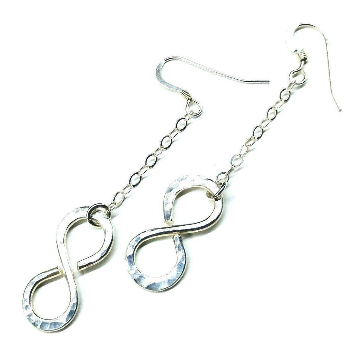 Sterling silver infinity earrings with hammer pattern by Blue Crius, showcasing elegant, textured design and hoop style.