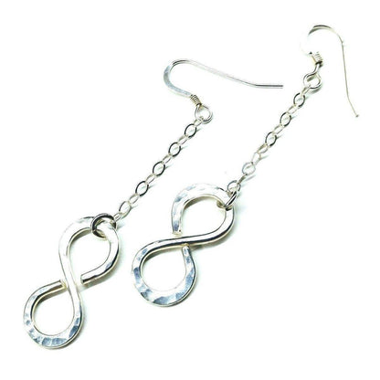 Sterling silver infinity earrings with hammer pattern by Blue Crius, showcasing elegant, textured design and hoop style.