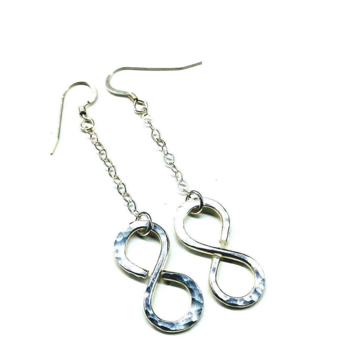 Sterling silver infinity earrings with hammer pattern by Blue Crius, featuring a sleek and stylish design.