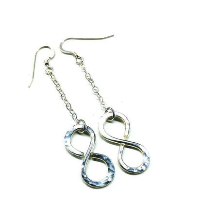 Sterling silver infinity earrings with hammer pattern by Blue Crius, featuring a sleek and stylish design.