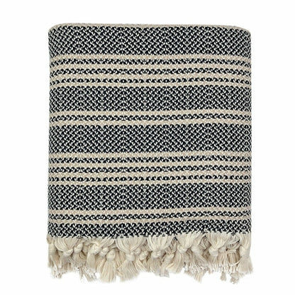 A woven Turkish throw blanket with black and white stripe design, ideal for home decor from Ariel.