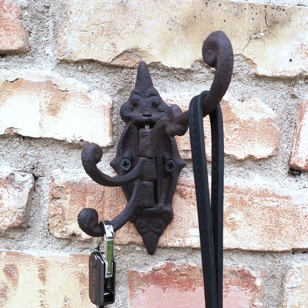 Set of two Yellow Icarus cast iron swivel wall hook brackets with three hooks each, 5.75 inches, ideal for home decor.