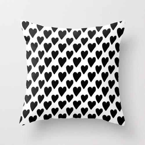 Black and white hearts patterned cushion by Scorpius, soft textile pillow with a charming heart design and plush appearance.