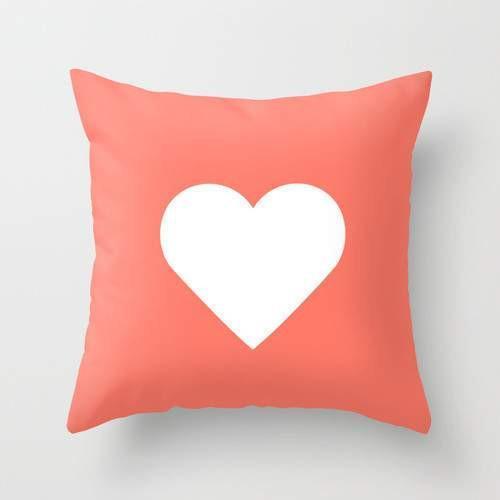 Peach heart-shaped pillow by Scorpius, soft textiles and cozy design perfect for decorative or comfort use.