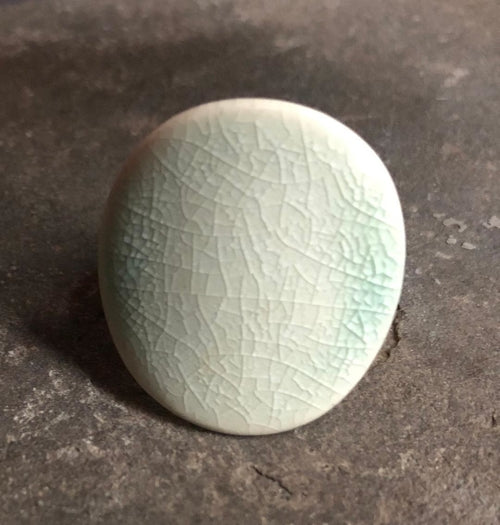 Adjustable handmade ceramic cocktail ring in teal with a bold statement design, crafted by Azure Nesoi.
