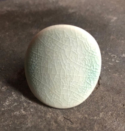Adjustable handmade ceramic cocktail ring in teal with a bold statement design, crafted by Azure Nesoi.