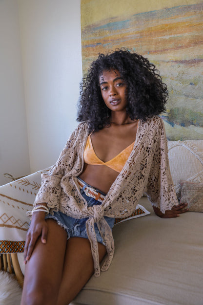 Tie-dye triangle style bralette by Periwinkle Aether showcasing soft fabric and vibrant tie-dye pattern in a close-up image.
