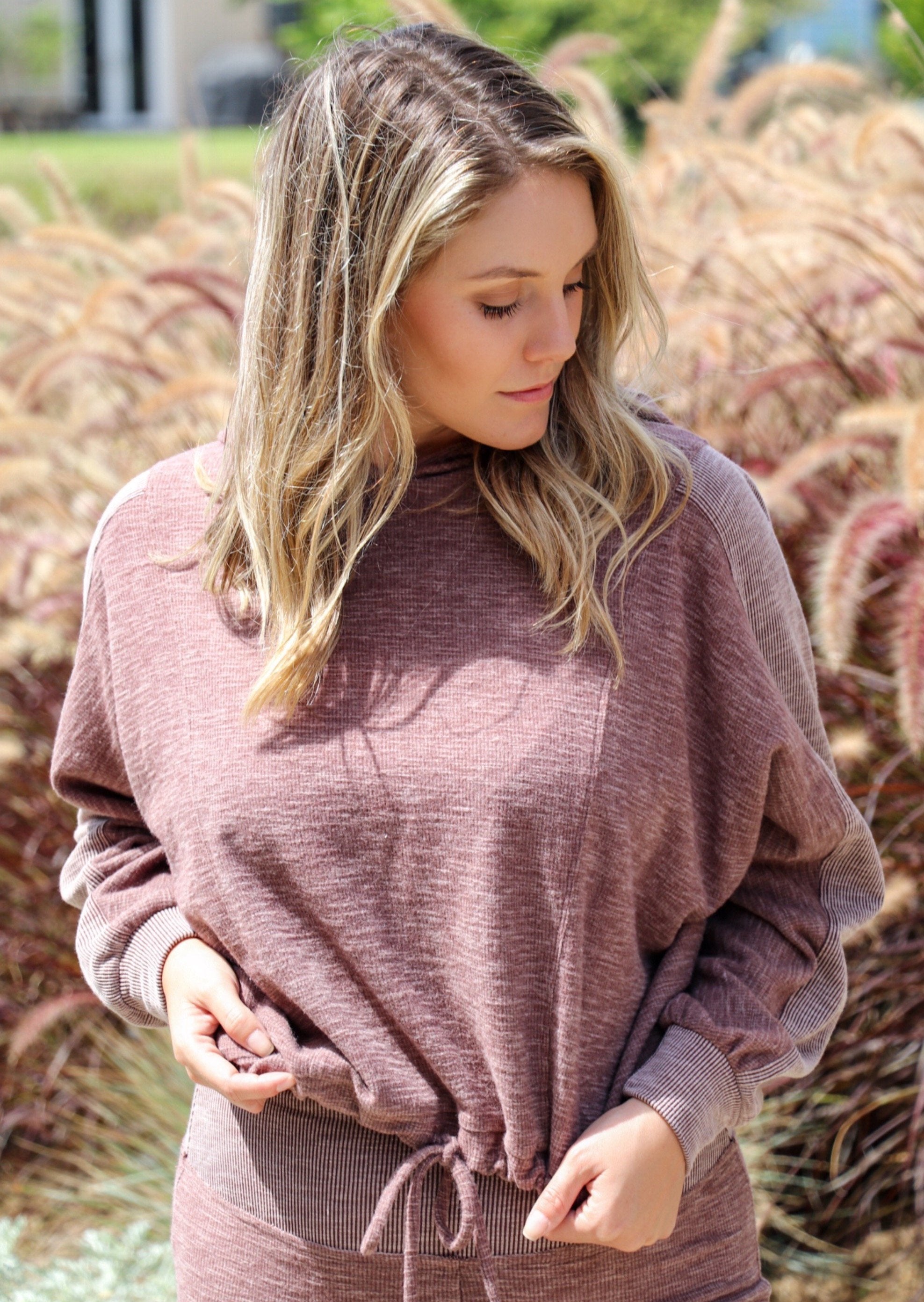 Close-up of taupe Morgan Flared Pants by Brown Tartarus showing ribbed fabric detail and wide-leg silhouette.