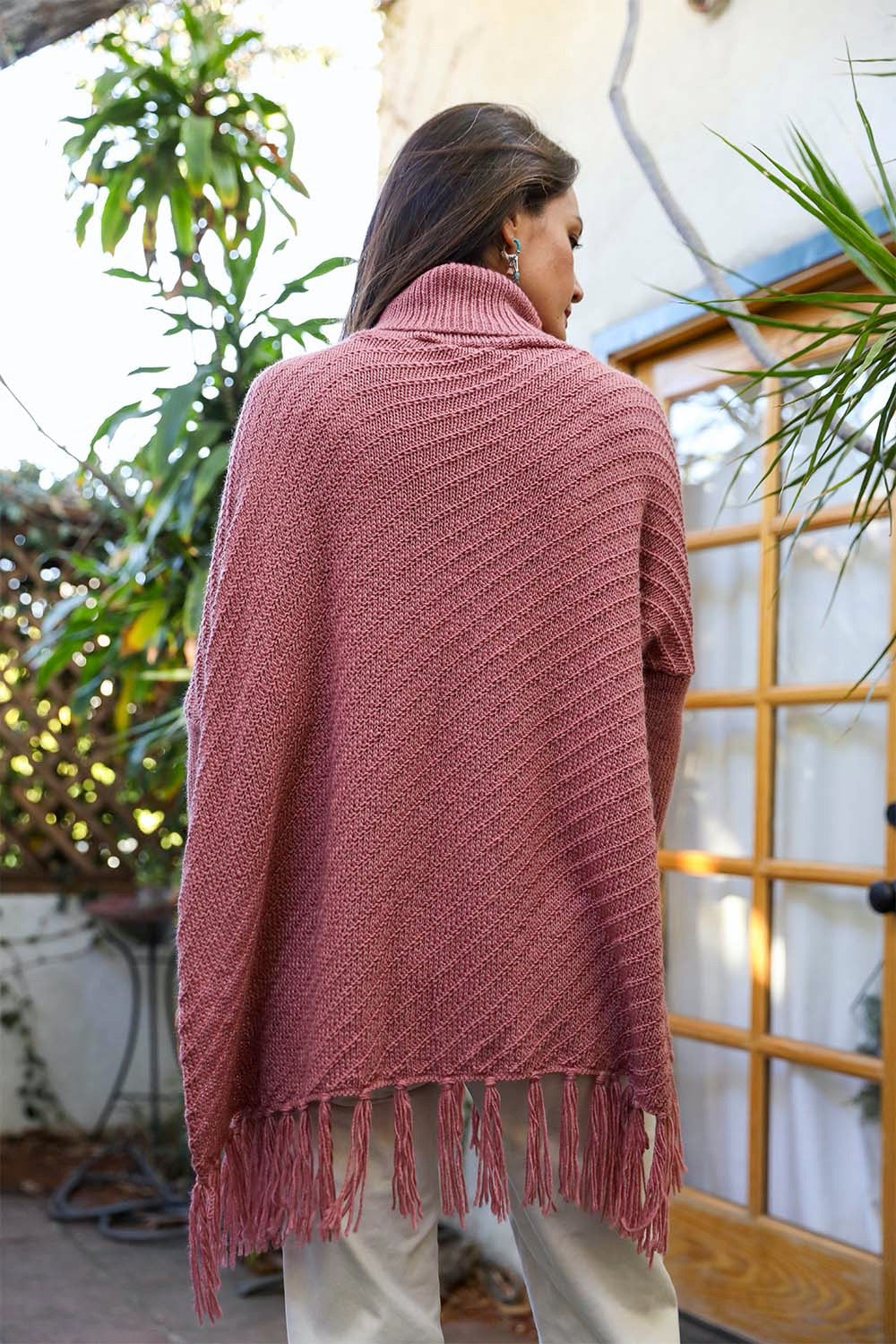 Start2Finish knit turtleneck poncho with frayed edges, featuring long sleeves and a cozy, stylish design.
