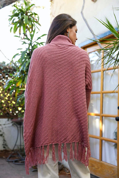 Start2Finish knit turtleneck poncho with frayed edges, featuring long sleeves and a cozy, stylish design.