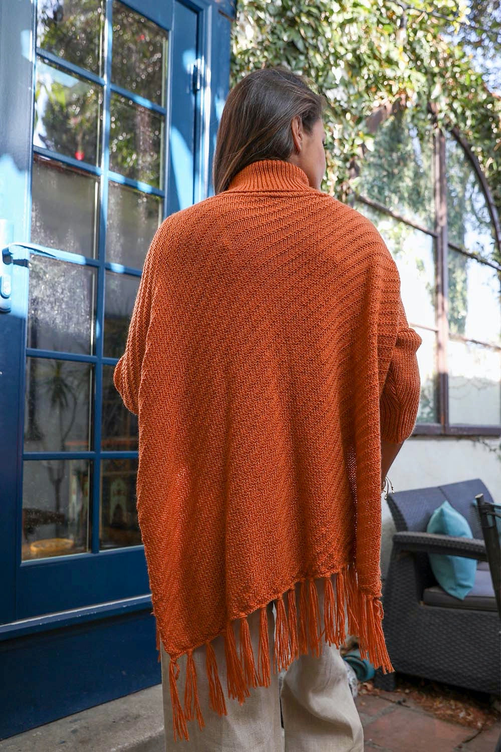 Start2Finish knit turtleneck poncho with frayed edges, featuring a cozy, stylish design and a cute, textured appearance.