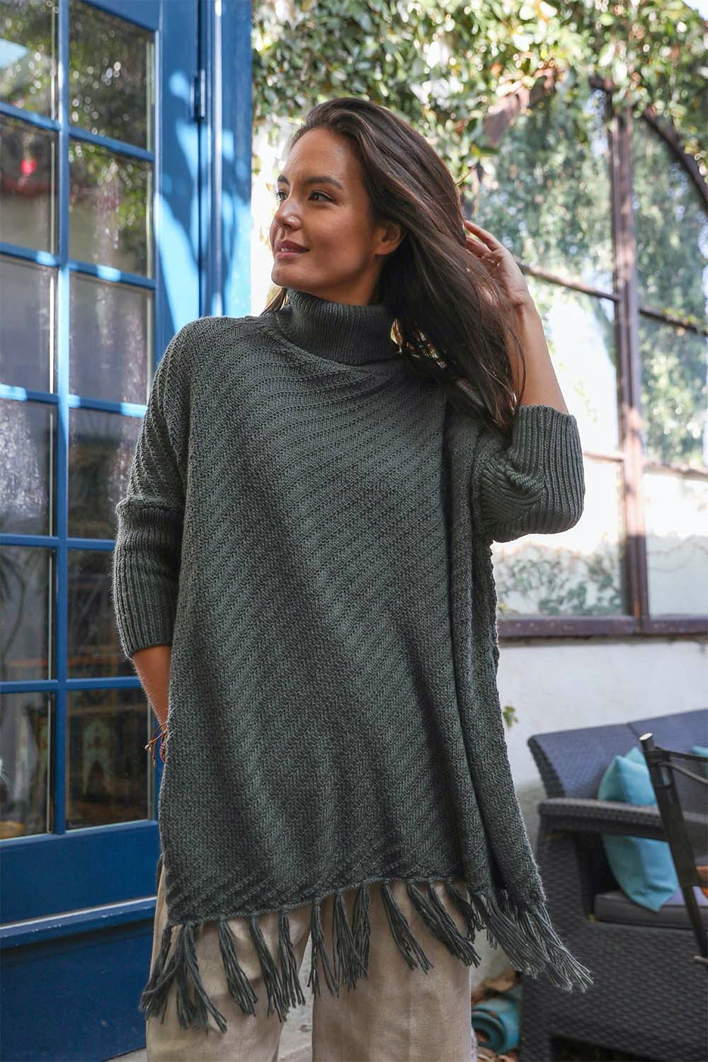 Start2Finish turtleneck knit poncho with frayed edges, featuring long sleeves and a cozy, stylish design.