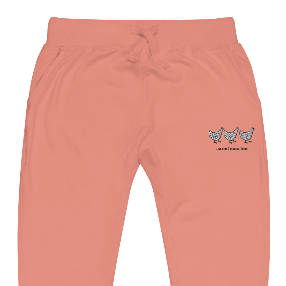 Yellow Eleusis Jacki Easlick Three Chickens unisex fleece sweatpants in dusty rose, shown in close-up detail.