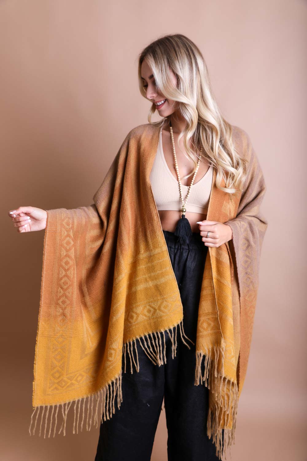 Western-style Colorblend Tassel Serape accessory by Periwinkle Aether featuring camel tones and vibrant tassel details.