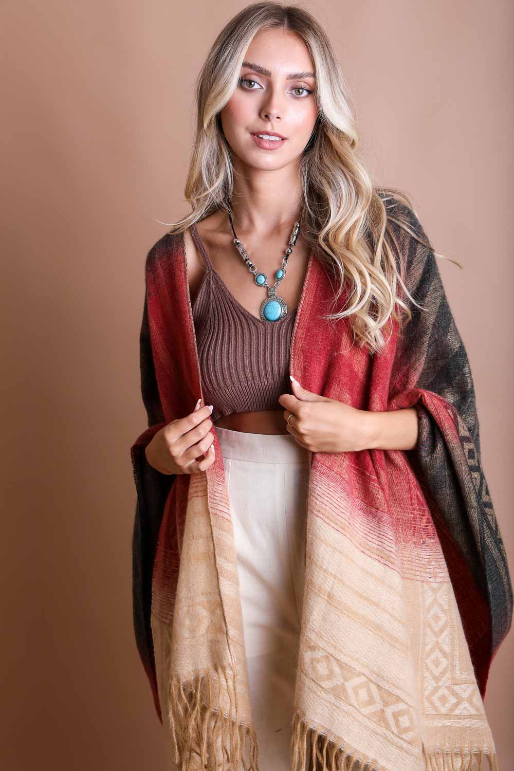 Colorful Western-style tassel serape accessory with vibrant color blends and fringe details, perfect for boho fashion.