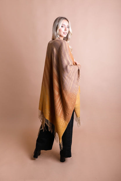 Colorful Western-style tassel serape accessory with vibrant color blends and decorative tassels, perfect for western fashion looks.