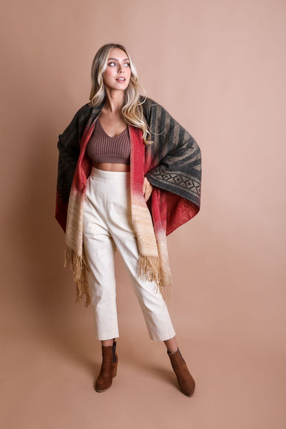 Colorful Western-style tassel serape accessory with vibrant color blends and decorative tassels, by Periwinkle Aether.