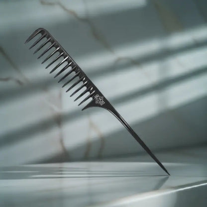 Peach Clymene wide-tooth detangler comb for gentle, tangle-free styling of hair or wigs, with wide spaced teeth for smooth combing.