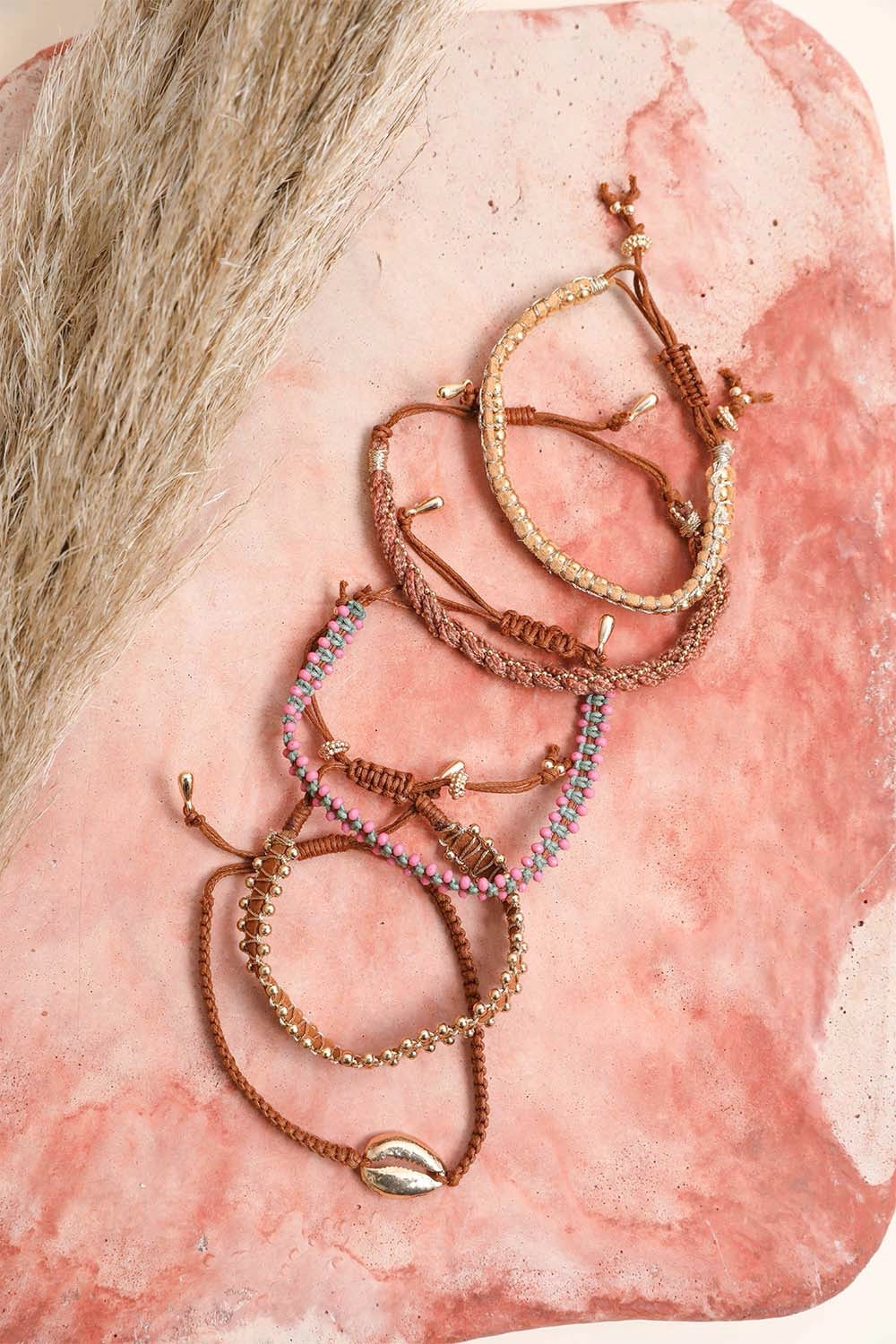 Woven stackable beaded bracelet by Periwinkle Aether featuring colorful beads and intricate weaving for stylish accessories.