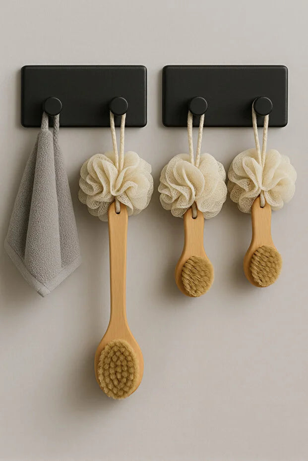 Set of four Gold Penelope self-adhesive wall hooks for bathroom and kitchen, easy to install on smooth surfaces.