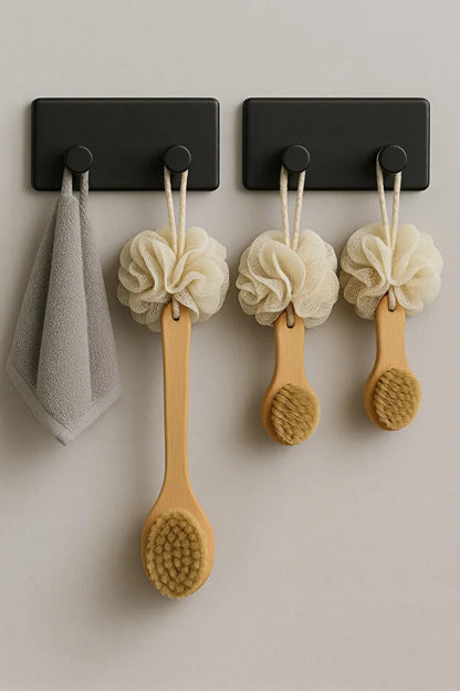 Set of four Gold Penelope self-adhesive wall hooks for bathroom and kitchen, easy to install on smooth surfaces.