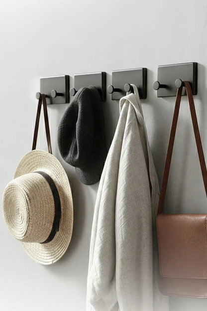 Set of four Gold Penelope self-adhesive wall hooks for bathroom and kitchen, easy to install, ideal for hanging accessories.