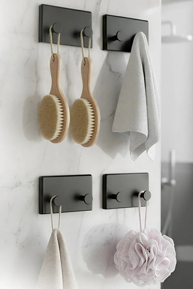 Gold Penelope 4-pack self-adhesive wall hooks for bathroom and kitchen, easy to install and ideal for hanging accessories.